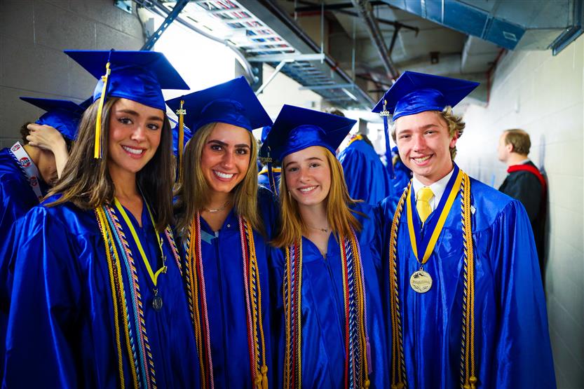 A group of graduates wearing blue robes